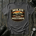 Miles Over Meeting T-shirt by The Riverstone Life on a dark heather Gildan Softstyle 64000 featuring a vintage highway and mountain design.