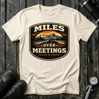 Miles Over Meeting T-shirt by The Riverstone Life on a natural Gildan Softstyle 64000 featuring a vintage highway and mountain design.