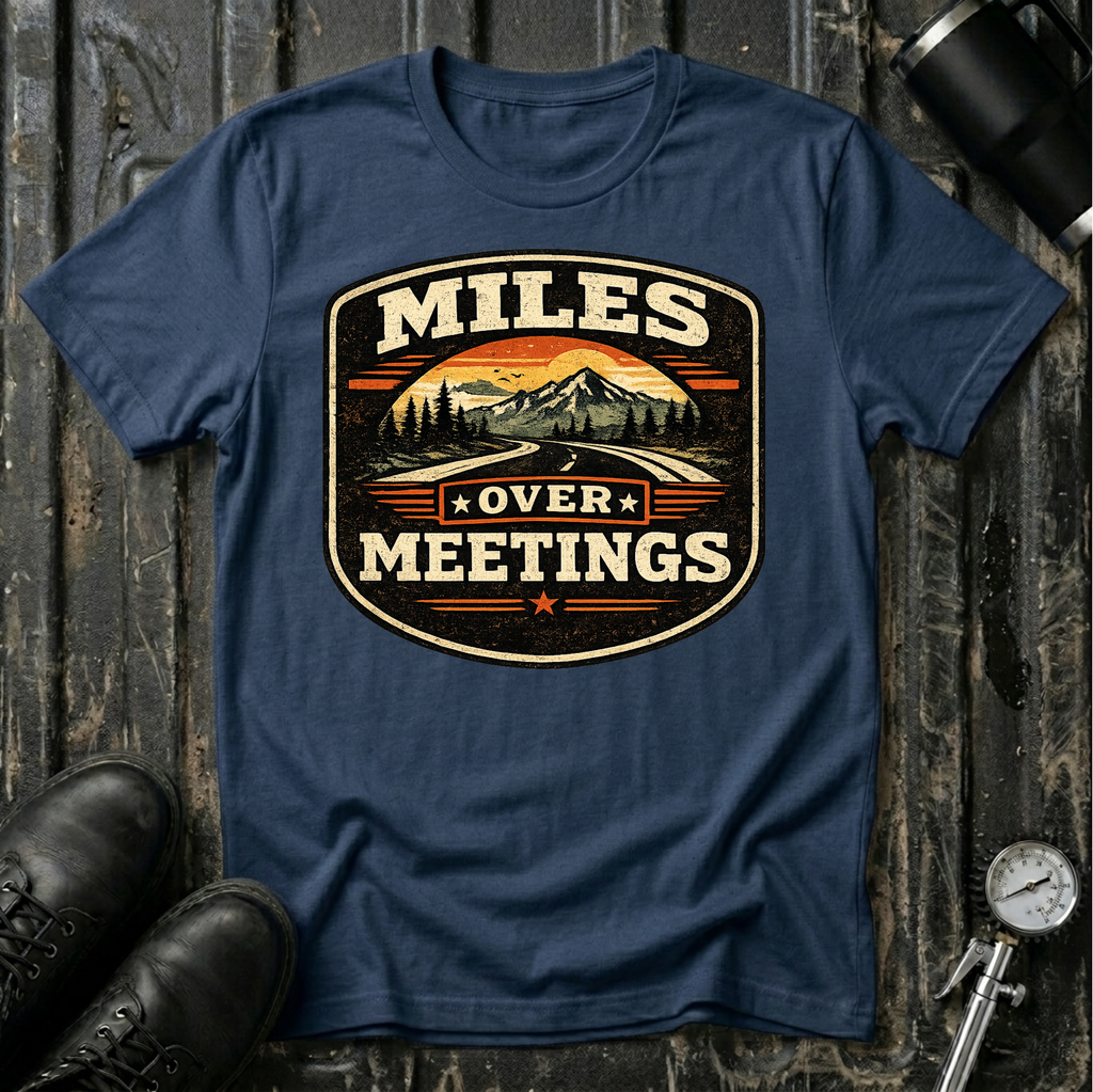 Miles Over Meeting T-shirt by The Riverstone Life on a navy Gildan Softstyle 64000 featuring a vintage highway and mountain design.