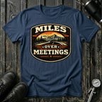 Miles Over Meeting T-shirt by The Riverstone Life on a navy Gildan Softstyle 64000 featuring a vintage highway and mountain design.