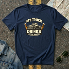 My Truck Drinks Better Than I Do T-shirt by The Riverstone Life on a navy Gildan Softstyle 64000 featuring a vintage pickup truck and humorous fuel themed design.