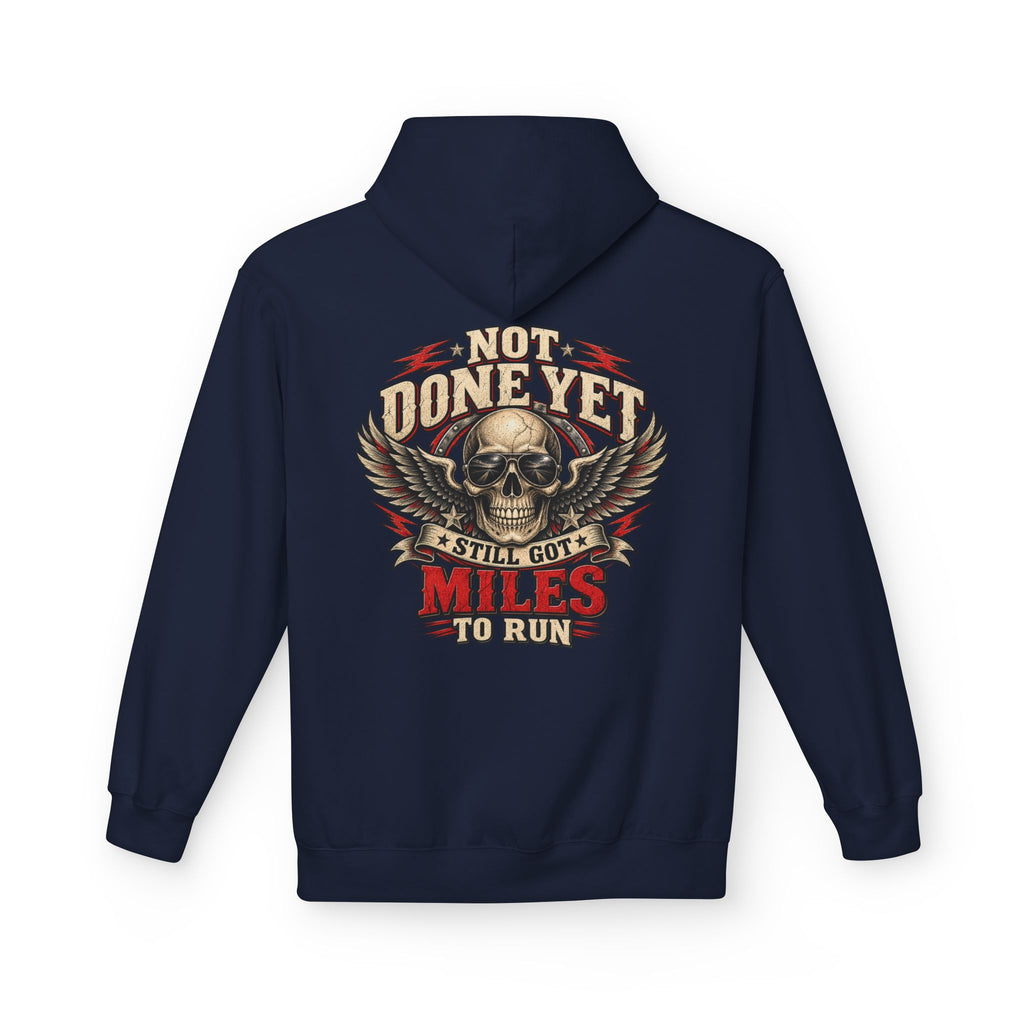 A navy blue hoodie shown from the back, featuring a large graphic print of a skull with wings and the text 'NOT DONE YET', 'STILL GOT', 'MILES TO RUN' in cream, red, and black.