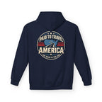 A navy blue pullover hoodie shown from the back, featuring a circular graphic print with the text 'PAID TO TRAVEL AMERICA' and 'THE ROAD IS THE JOB' in cream, red, and blue.