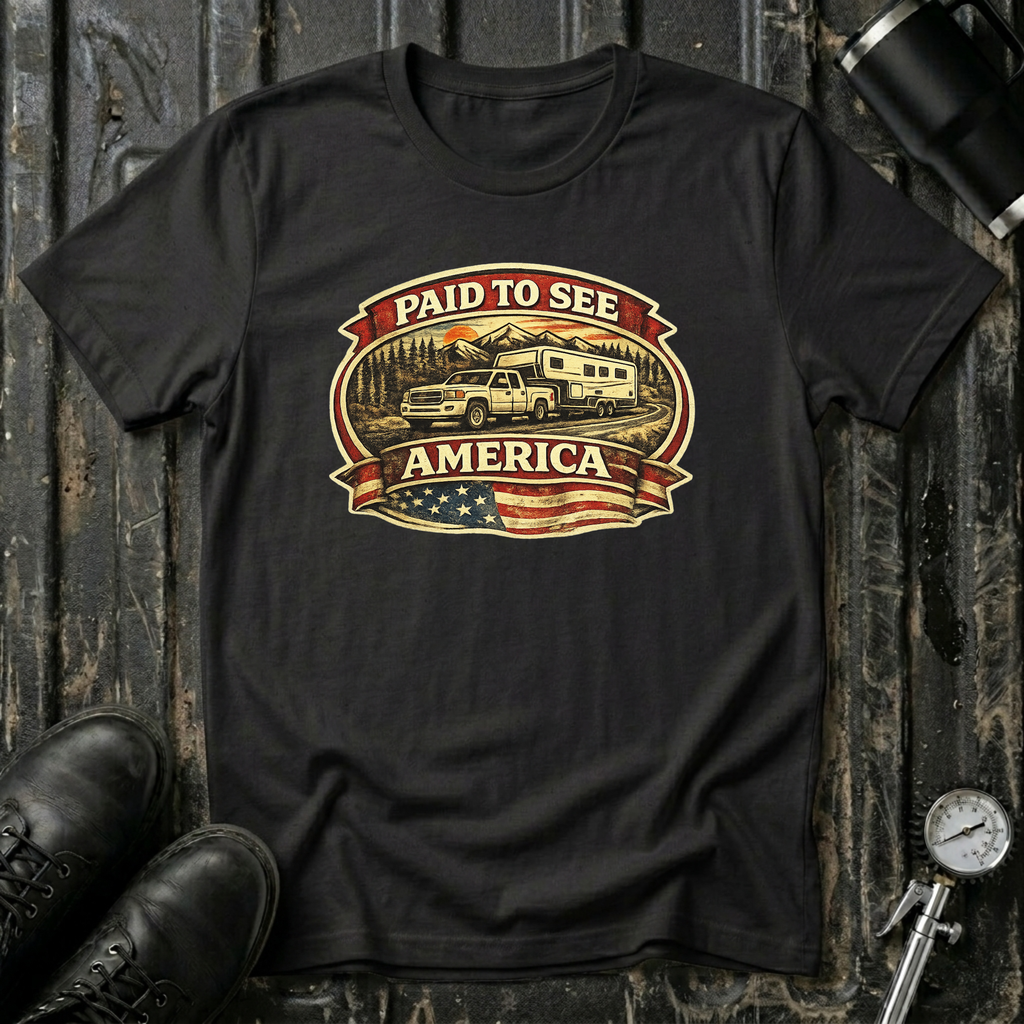 Black RV Transport T-shirt featuring a white pickup truck towing a camper, an America flag, and a phrase "Paid to See America"