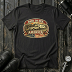 Black RV Transport T-shirt featuring a white pickup truck towing a camper, an America flag, and a phrase "Paid to See America"