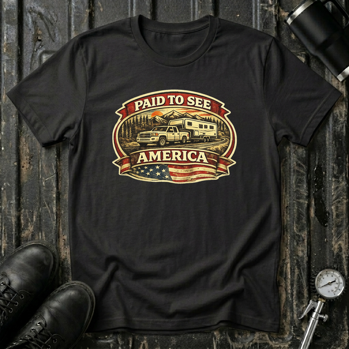 Black RV Transport T-shirt featuring a white pickup truck towing a camper, an America flag, and a phrase "Paid to See America"