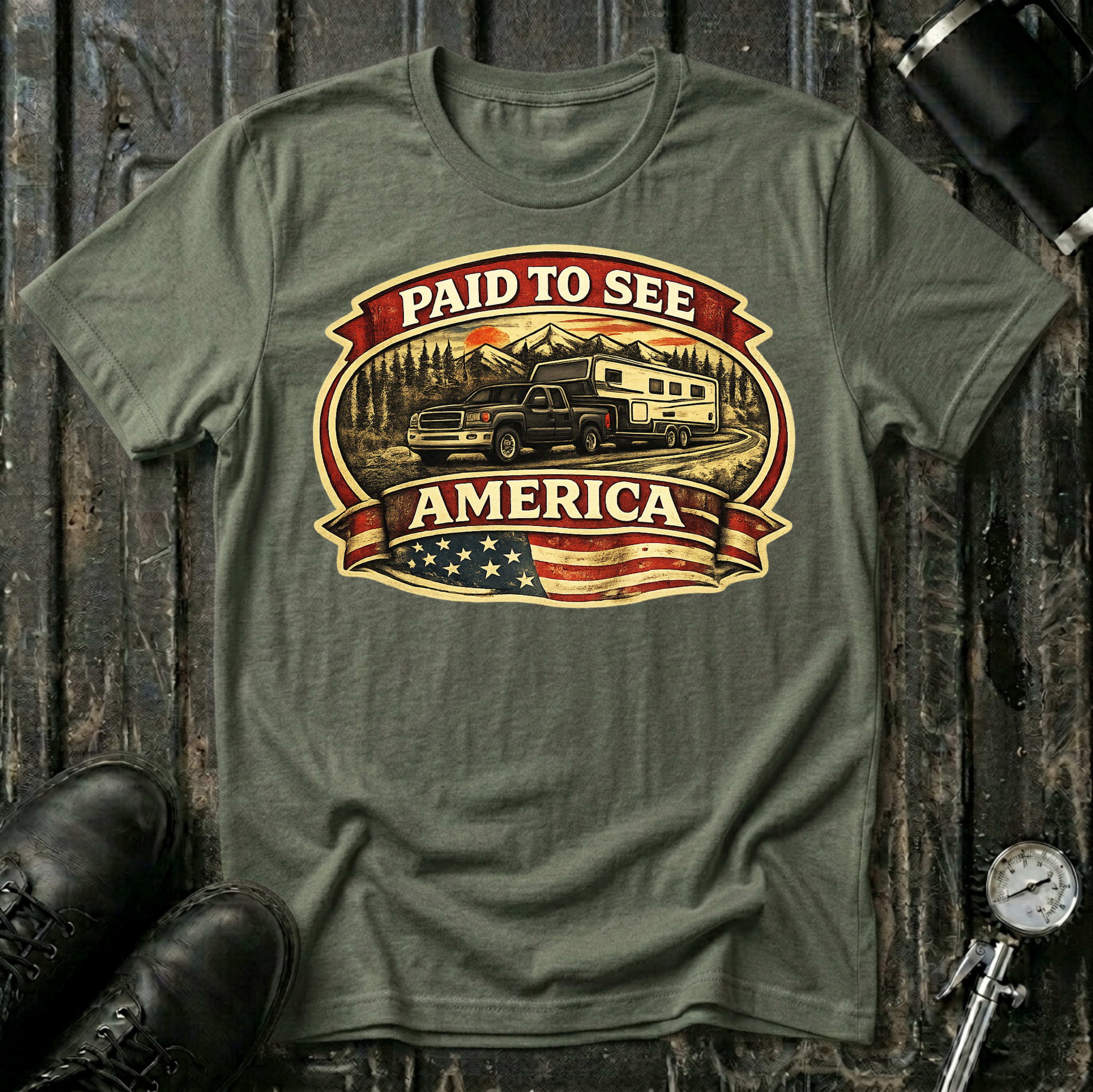 Paid to See America dark truck T-shirt by The Riverstone Life on a military green Gildan Softstyle 64000 featuring a pickup truck hauling a fifth-wheel with an American flag and scenic landscape.