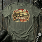 Paid to See America light truck T-shirt by The Riverstone Life on a military green Gildan Softstyle 64000 featuring a pickup truck hauling a fifth-wheel with an American flag and scenic landscape.