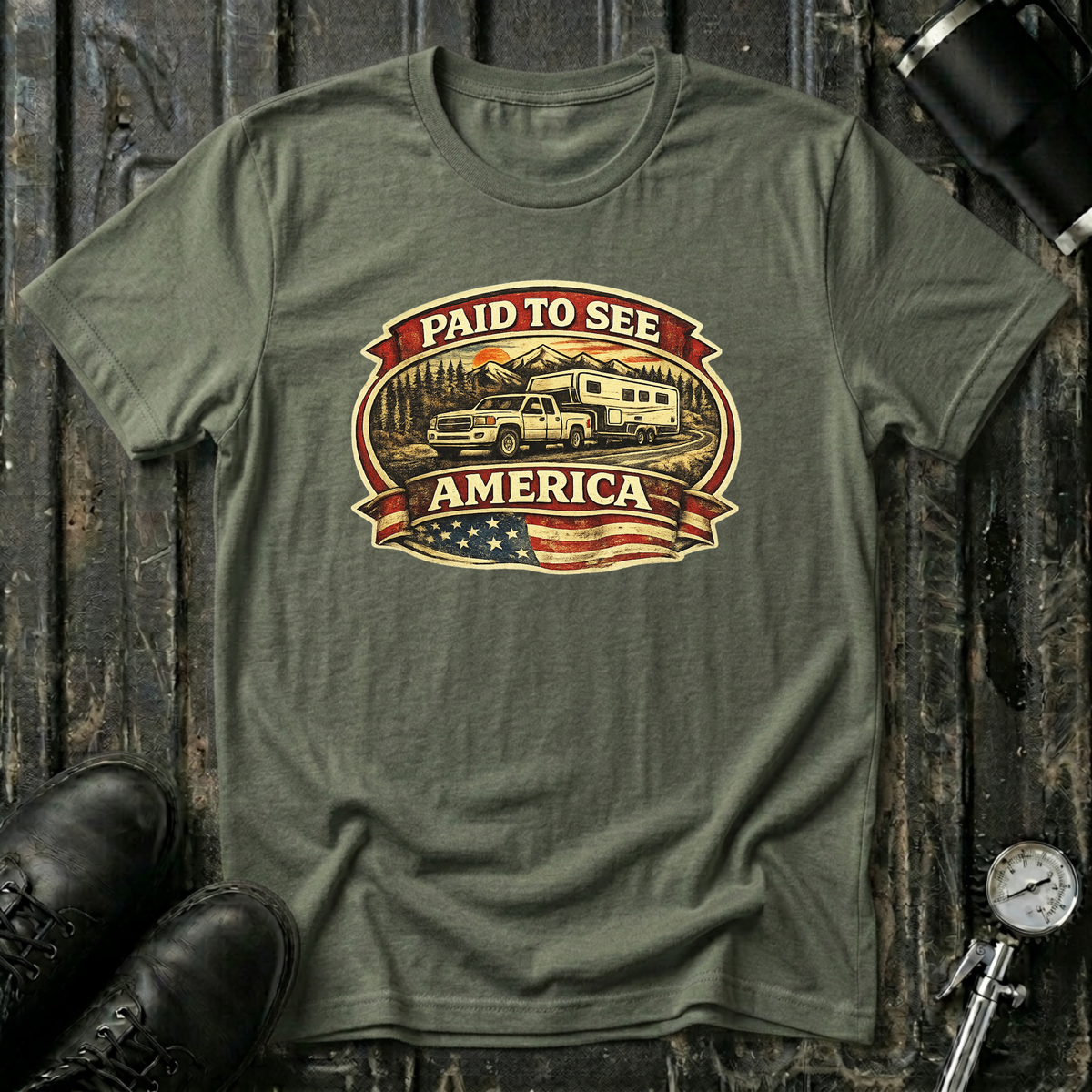 Military green  RV Transport T-shirt featuring a white pickup truck towing a camper, an America flag, and a phrase "Paid to See America"