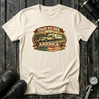 Natural RV Transport T-shirt featuring a white pickup truck towing a camper, an America flag, and a phrase "Paid to See America"