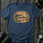 Navy RV Transport T-shirt featuring a white pickup truck towing a camper, an America flag, and a phrase "Paid to See America"