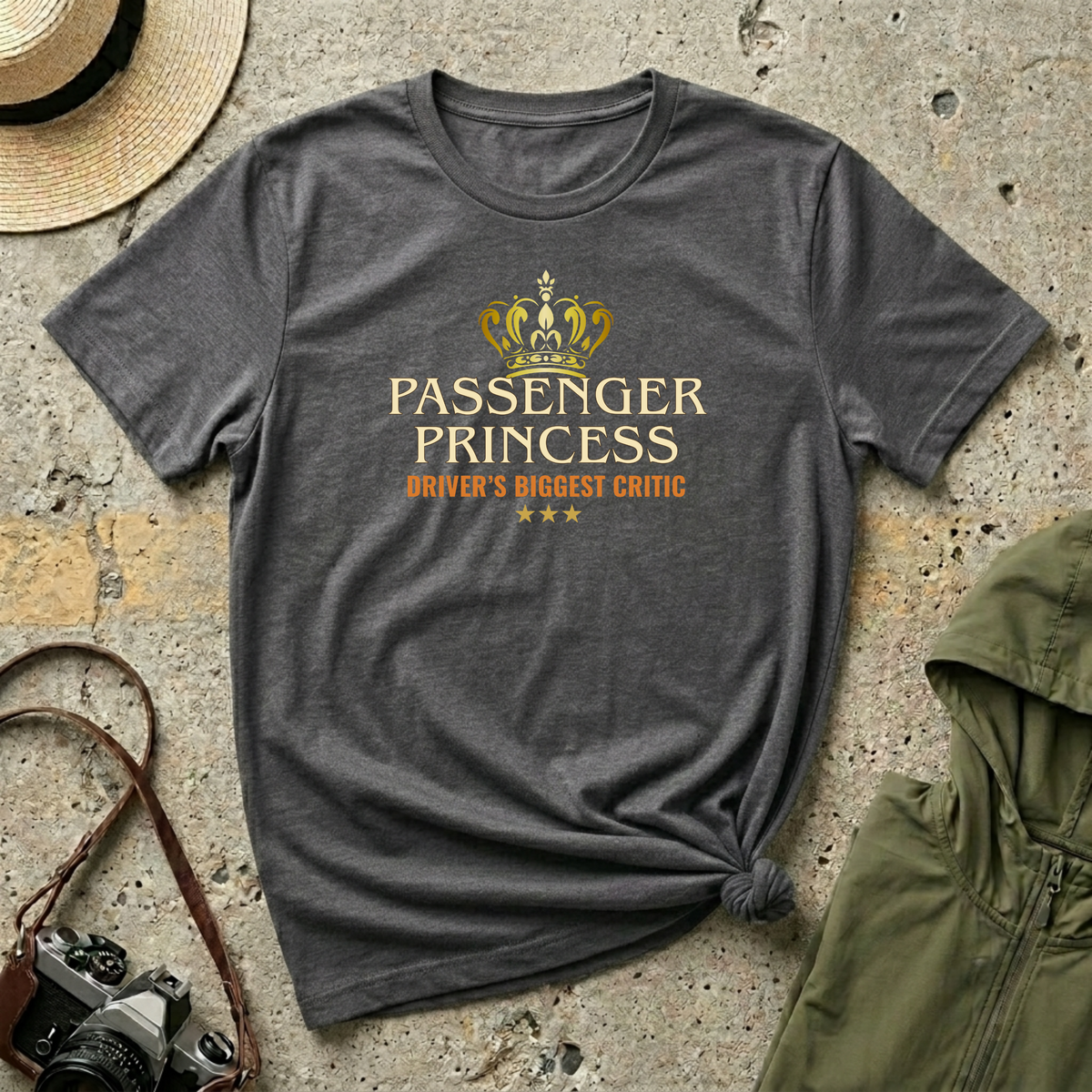 Dark heather 'Passenger Princess Driver's Biggest Critic' t-shirt featuring a gold crown and vintage inspired typography with three gold stars