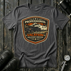 Professional Vacation Delivery Driver dark truck T-shirt by The Riverstone Life on a dark heather Gildan Softstyle 64000 featuring a pickup truck hauling a fifth-wheel Rv through a mountain landscape.