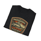 Black folded RV Transport T-shirt featuring a light pickup truck towing a camper with the phrase "Professional Vacation Delivery Driver" in a vintage badge design.