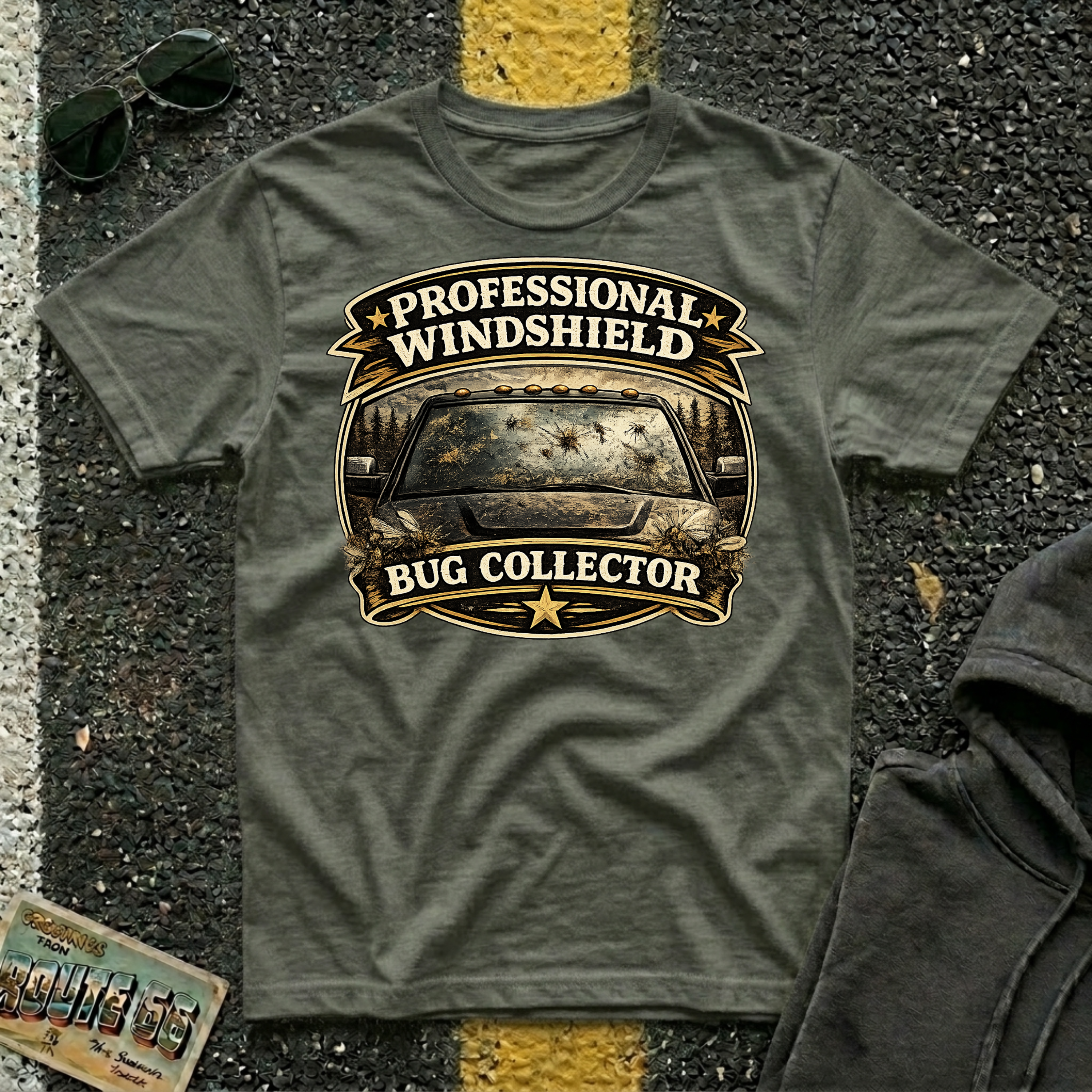 Professional Windshield Bug Collector by The Riverstone Life on a military green Gildan Softstyle 64000 featuring a humorious vintage road design with smashed bugs on the truck.
