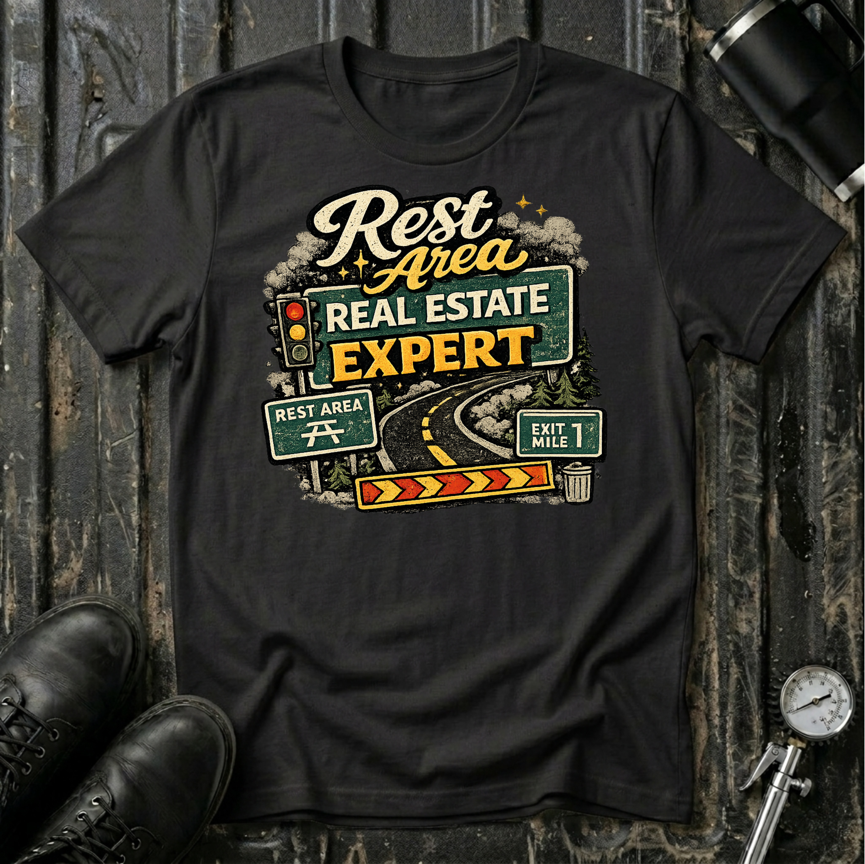 Rest Area Real Estate Expert T-shirt by The Riverstone Life featuring a black Gildan Softstyle 64000 featuring a humorous highway and rest area design for RV Transport drivers and road travelers.