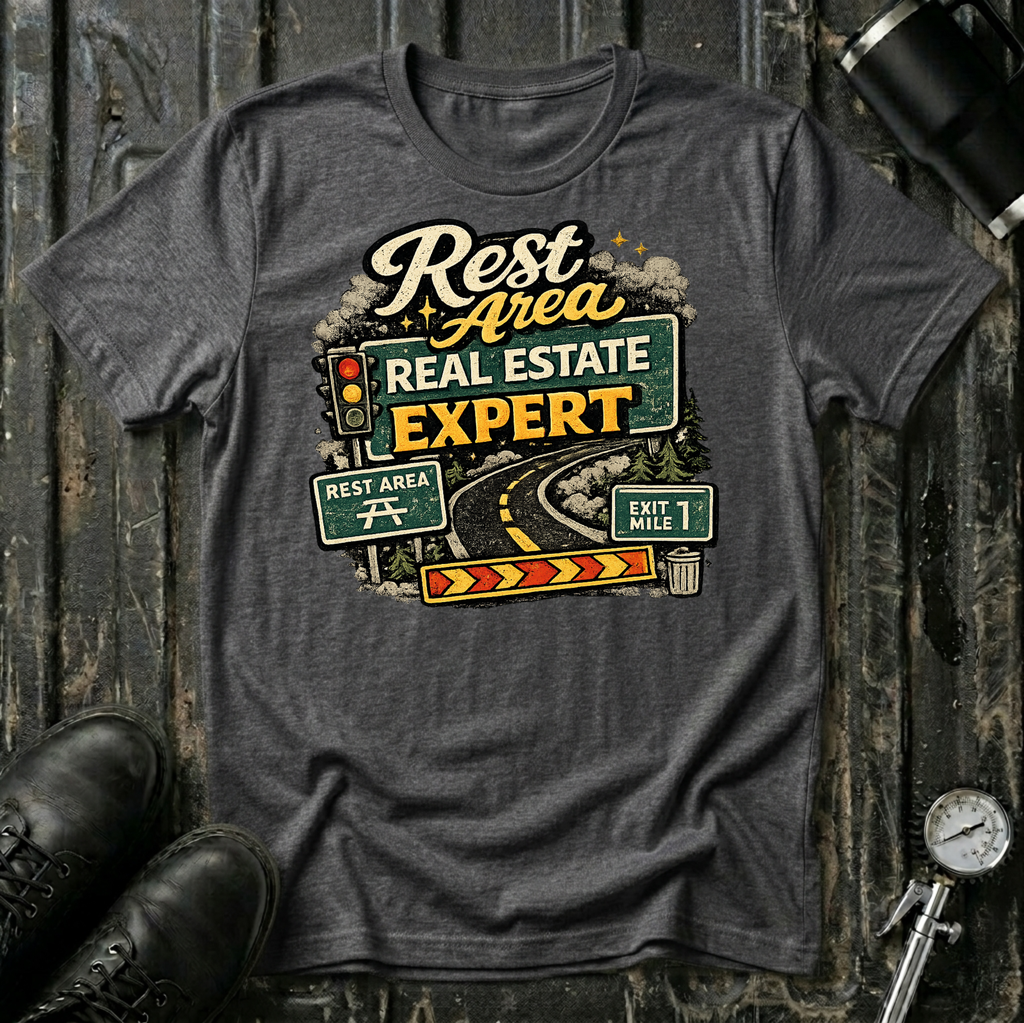 Rest Area Real Estate Expert T-shirt by The Riverstone Life featuring a dark heather Gildan Softstyle 64000 featuring a humorous highway and rest area design for RV Transport drivers and road travelers.