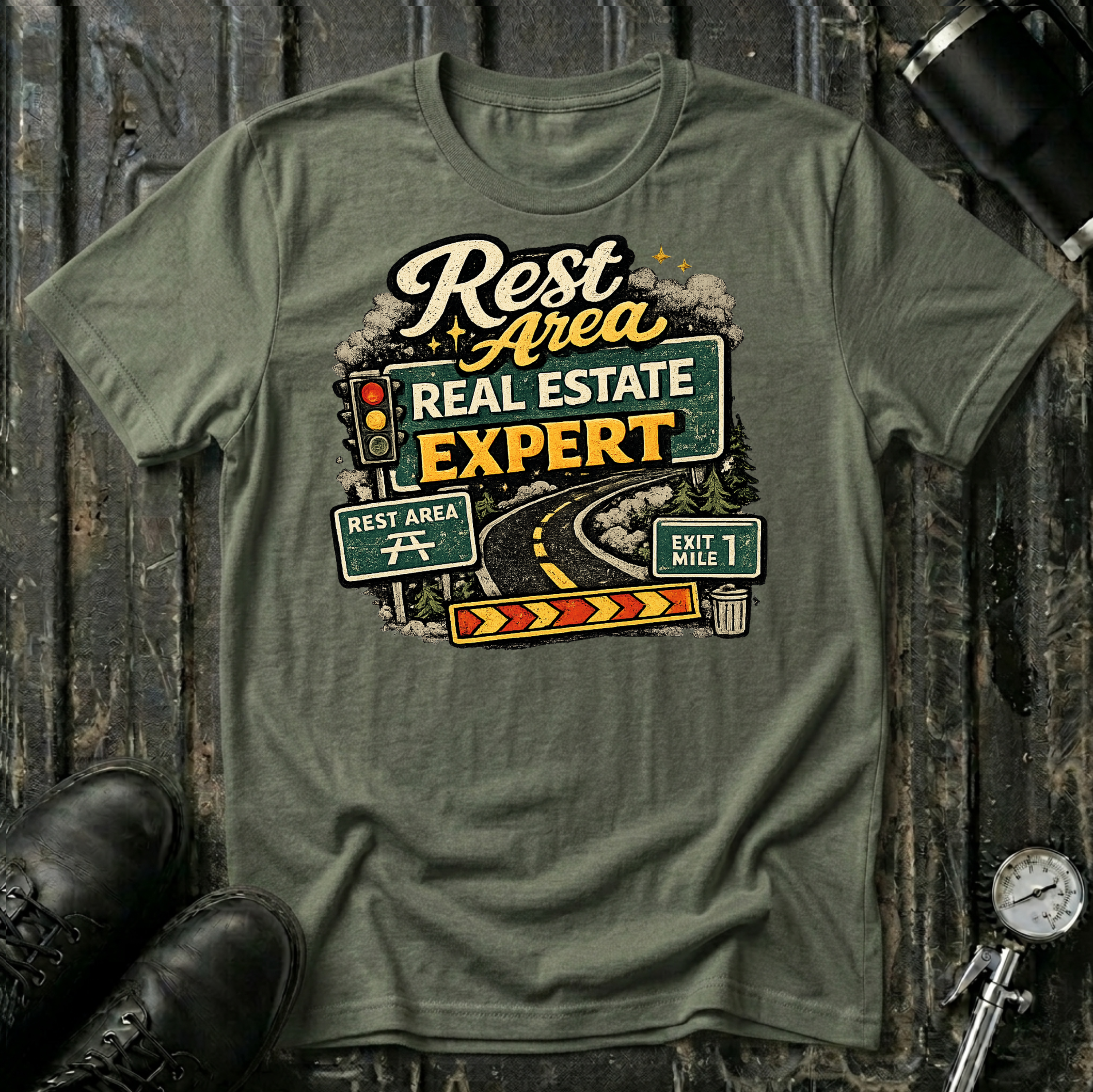 Rest Area Real Estate Expert T-shirt by The Riverstone Life featuring a military green Gildan Softstyle 64000 featuring a humorous highway and rest area design for RV Transport drivers and road travelers.