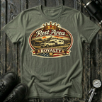 Rest Area Royalty T-shirt by The Riverstone Life on a military green Gildan Softstyle 64000 featuring a pickup truck towing an RV at a scenic rest area.