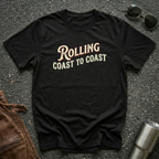 Black road life T-shirt featuring the phrase "Rolling Coast to Coast" in a vintage cream and maroon typography
