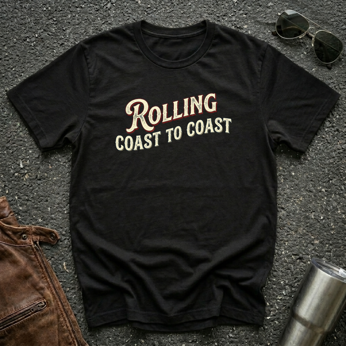 Black road life T-shirt featuring the phrase "Rolling Coast to Coast" in a vintage cream and maroon typography