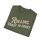 A folded military green t-shirt with the phrase 'ROLLING COAST TO COAST' printed across the front in a cream-colored retro font with a maroon shadow outline, shown on a plain white background.