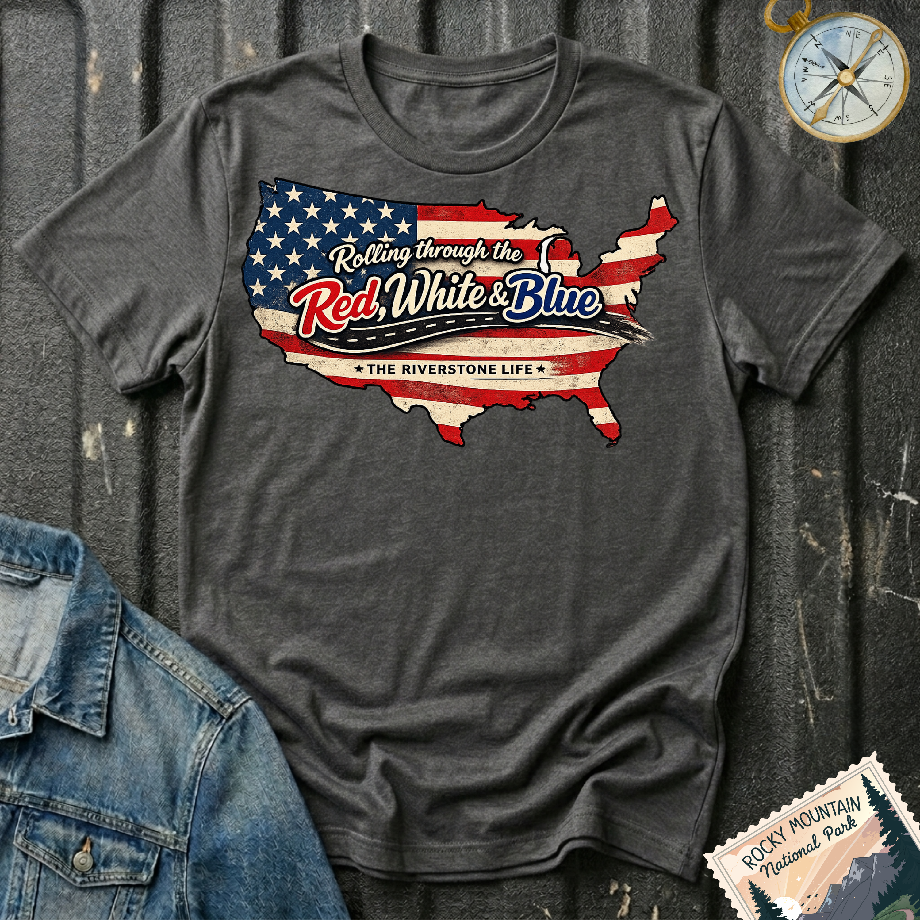Rolling Through the Red, White & Blue T-shirt by The Riverstone Life on a dark heather Gildan Softstyle 64000 featuring a vintage United States map with patriotic red, white and blue graphics.