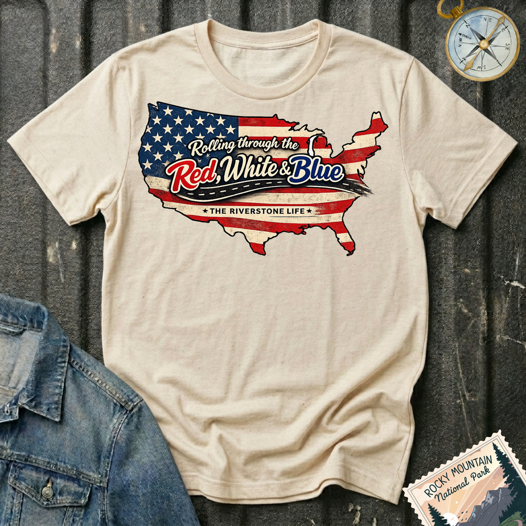 Rolling Through the Red, White & Blue T-shirt by The Riverstone Life on a natural Gildan Softstyle 64000 featuring a vintage United States map with patriotic red, white and blue graphics.