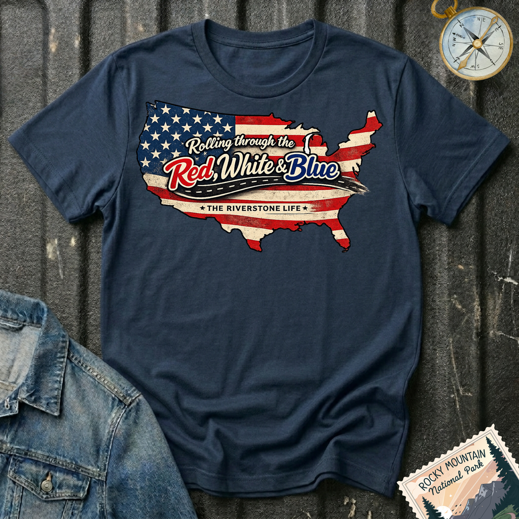 Rolling Through the Red, White & Blue T-shirt by The Riverstone Life on a navy Gildan Softstyle 64000 featuring a vintage United States map with patriotic red, white and blue graphics.