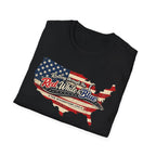 Black folded t-shirt with American flag design and text 'Rolling Through the Red, White and Blue The Riverstone Life' on a white background