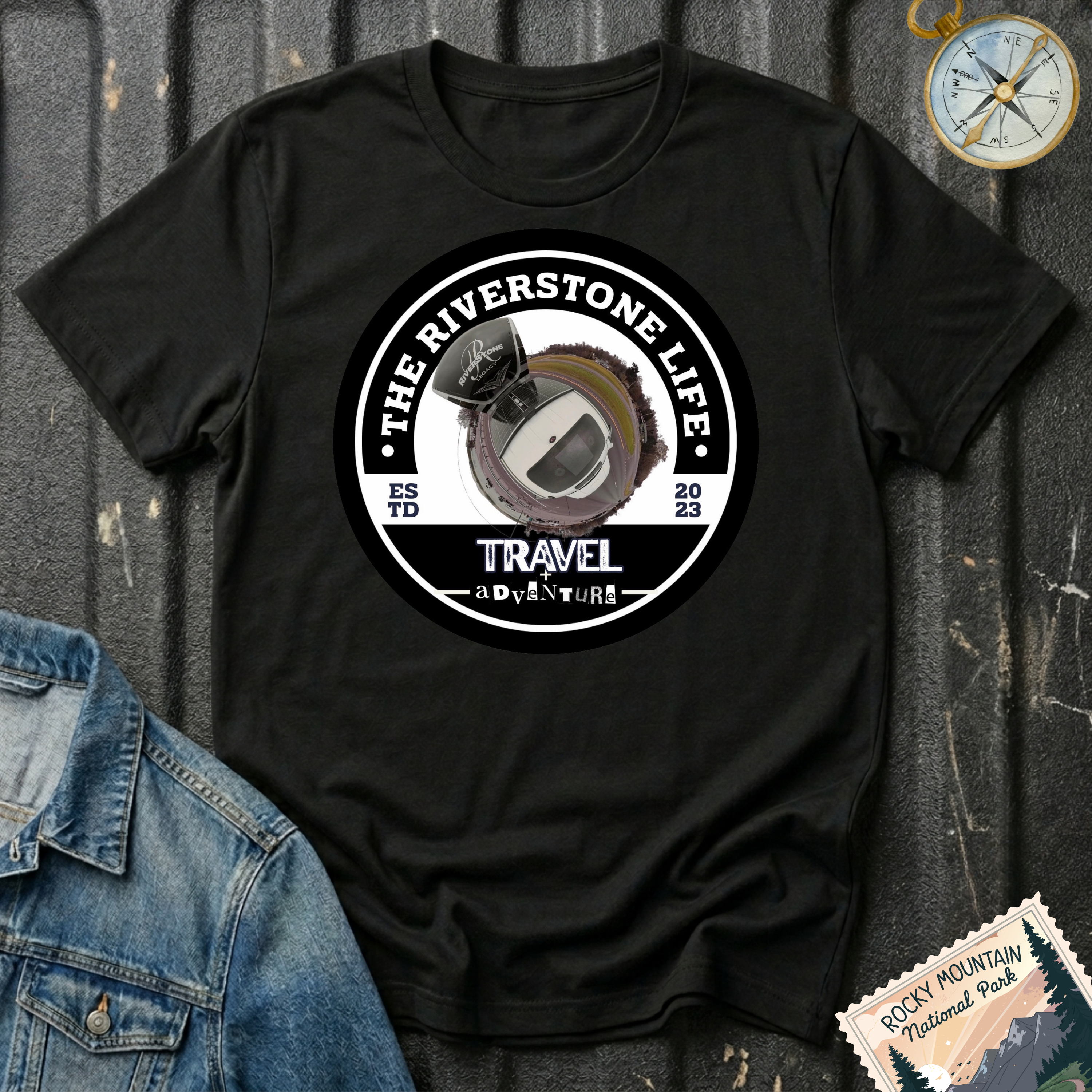 The Riverstone Life 2023 T-shirt by The Riverstone Life on a black Gildan Softstyle 64000 featuring the official circular travel logo with a pickup truck and fifth-wheel RV.