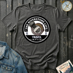 The Riverstone Life 2023 T-shirt by The Riverstone Life on a dark heather Gildan Softstyle 64000 featuring the official circular travel logo with a pickup truck and fifth-wheel RV.