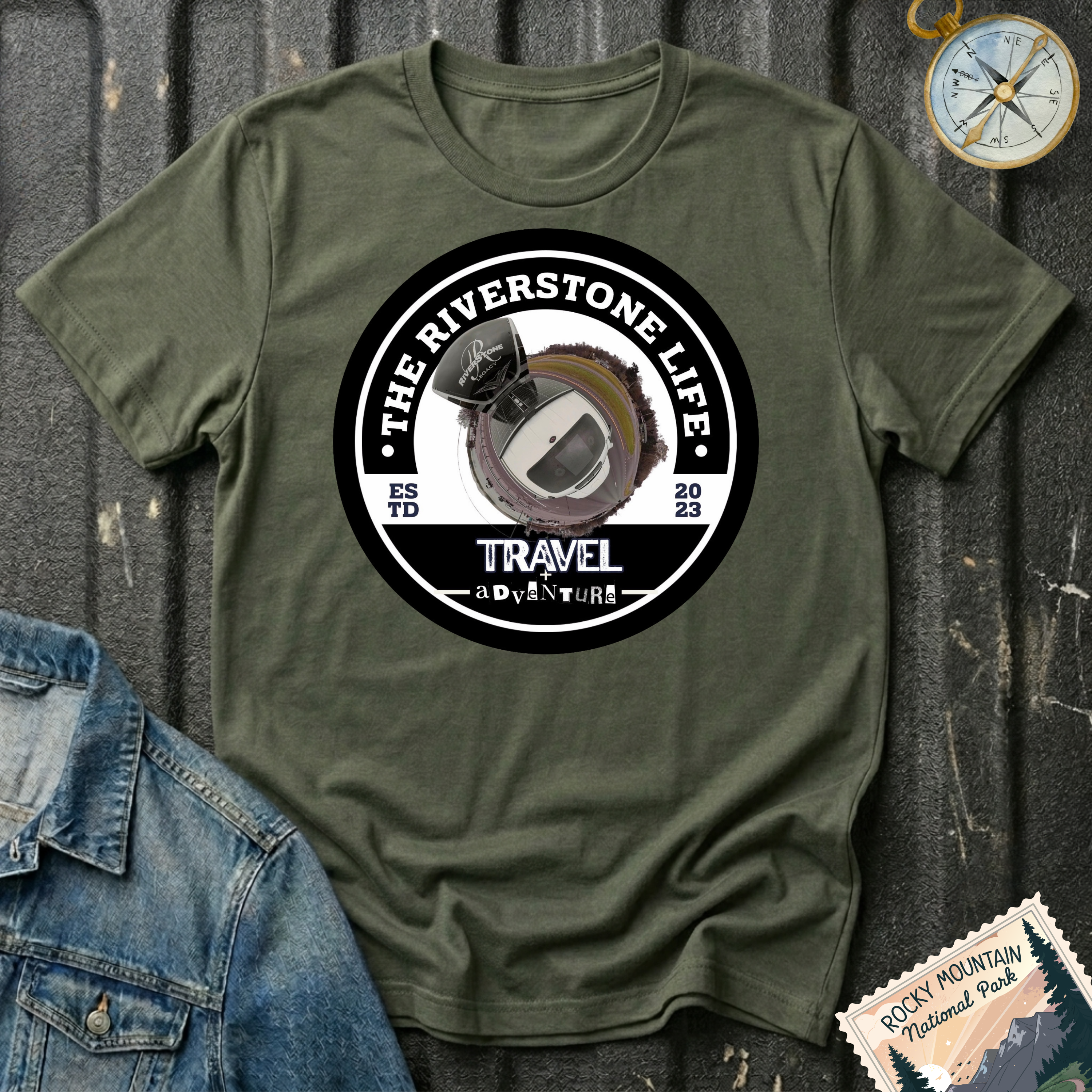 The Riverstone Life 2023 T-shirt by The Riverstone Life on a military green Gildan Softstyle 64000 featuring the official circular travel logo with a pickup truck and fifth-wheel RV.