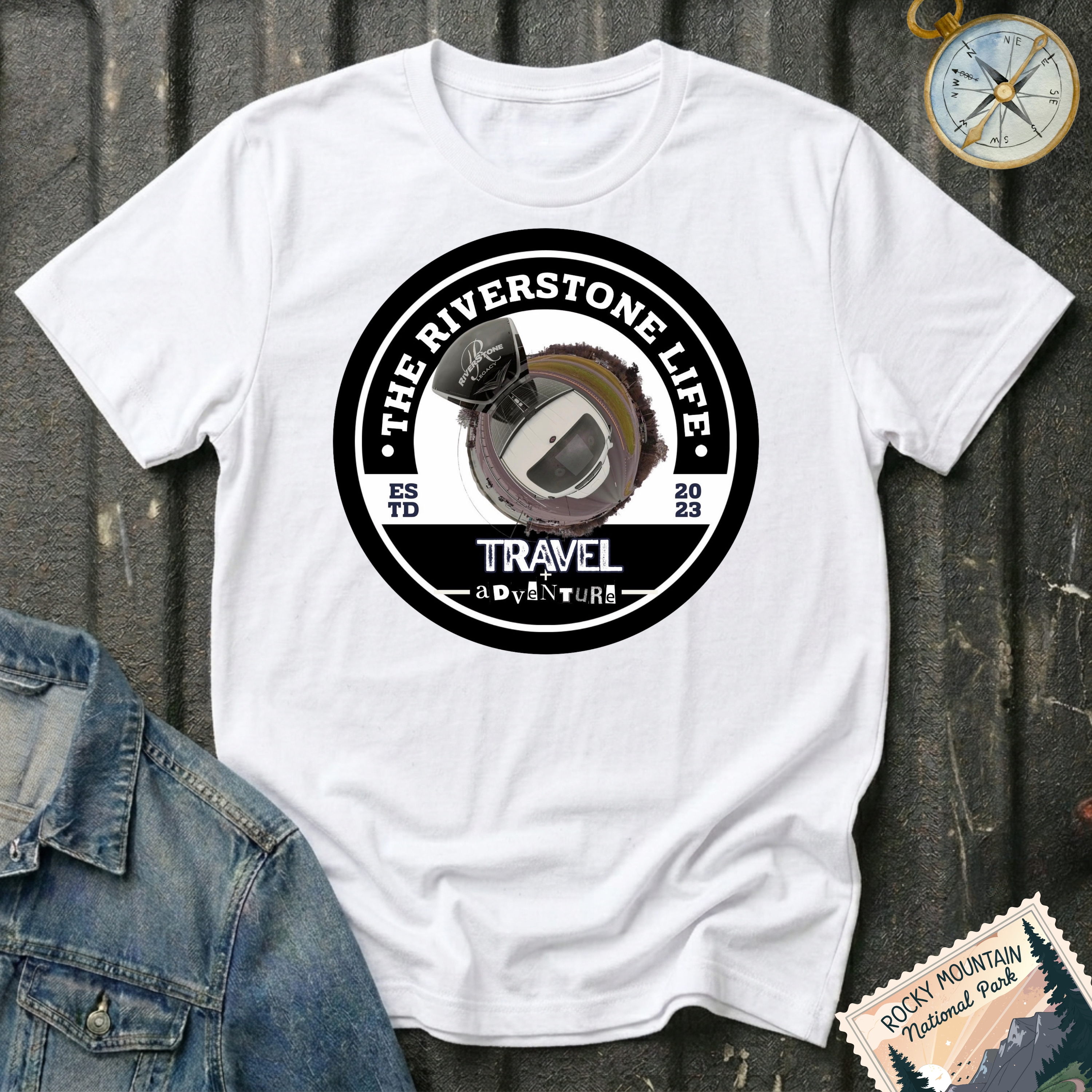 The Riverstone Life 2023 T-shirt by The Riverstone Life on a white Gildan Softstyle 64000 featuring the official circular travel logo with a pickup truck and fifth-wheel RV.