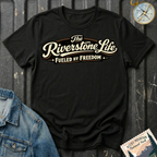 The Riverstone Life–Fueled by Freedom T-shirt on a black Gildan Softstyle 64000 featuring the official The Riverstone Life logo.