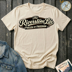 The Riverstone Life–Fueled by Freedom T-shirt on a natural Gildan Softstyle 64000 featuring the official The Riverstone Life logo.