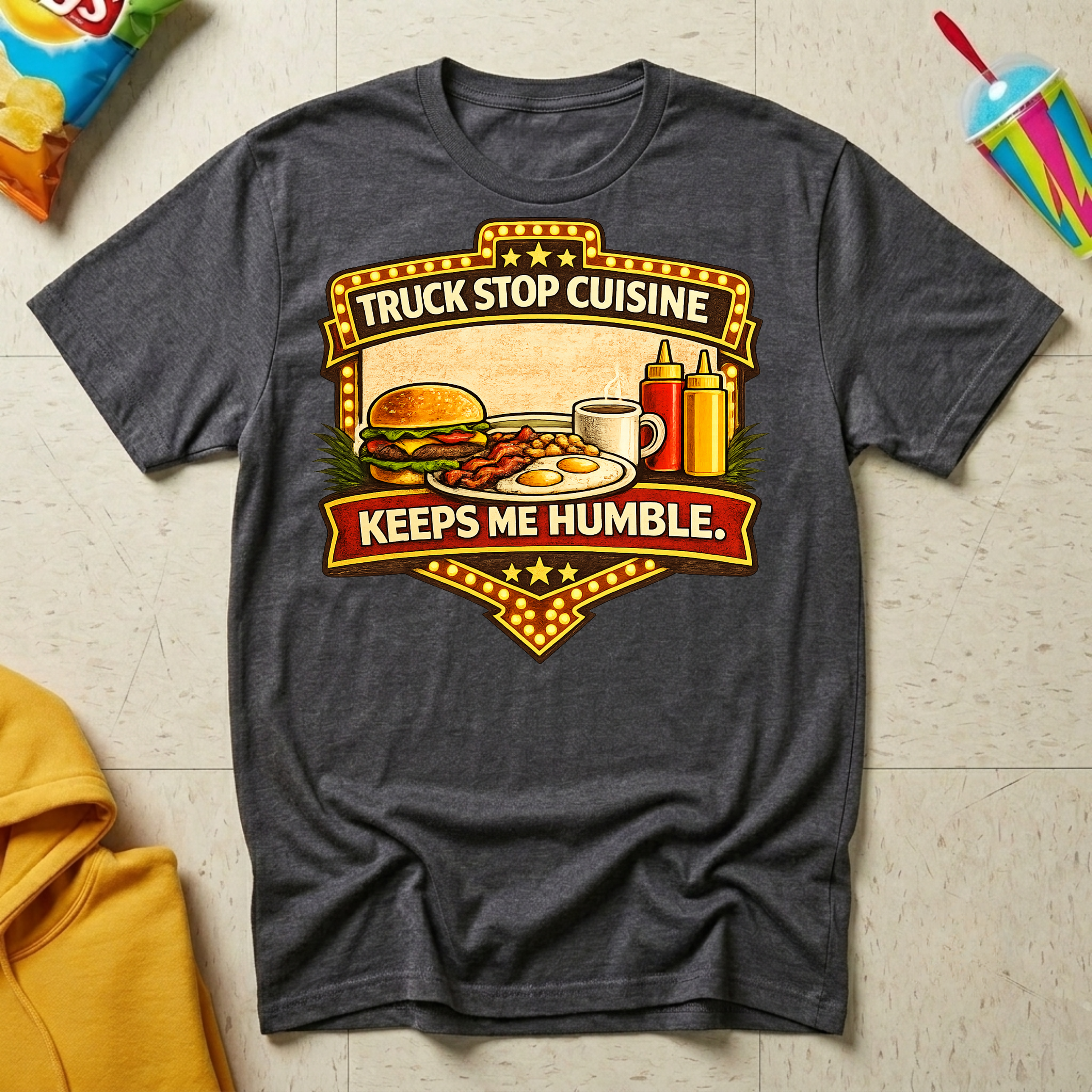 Truck Stop Cuisine Keeps Me Humble T-shirt by The Riverstone Life on a dark heather Gildan Softstyle 64000 featuring a vintage truck stop food graphic.