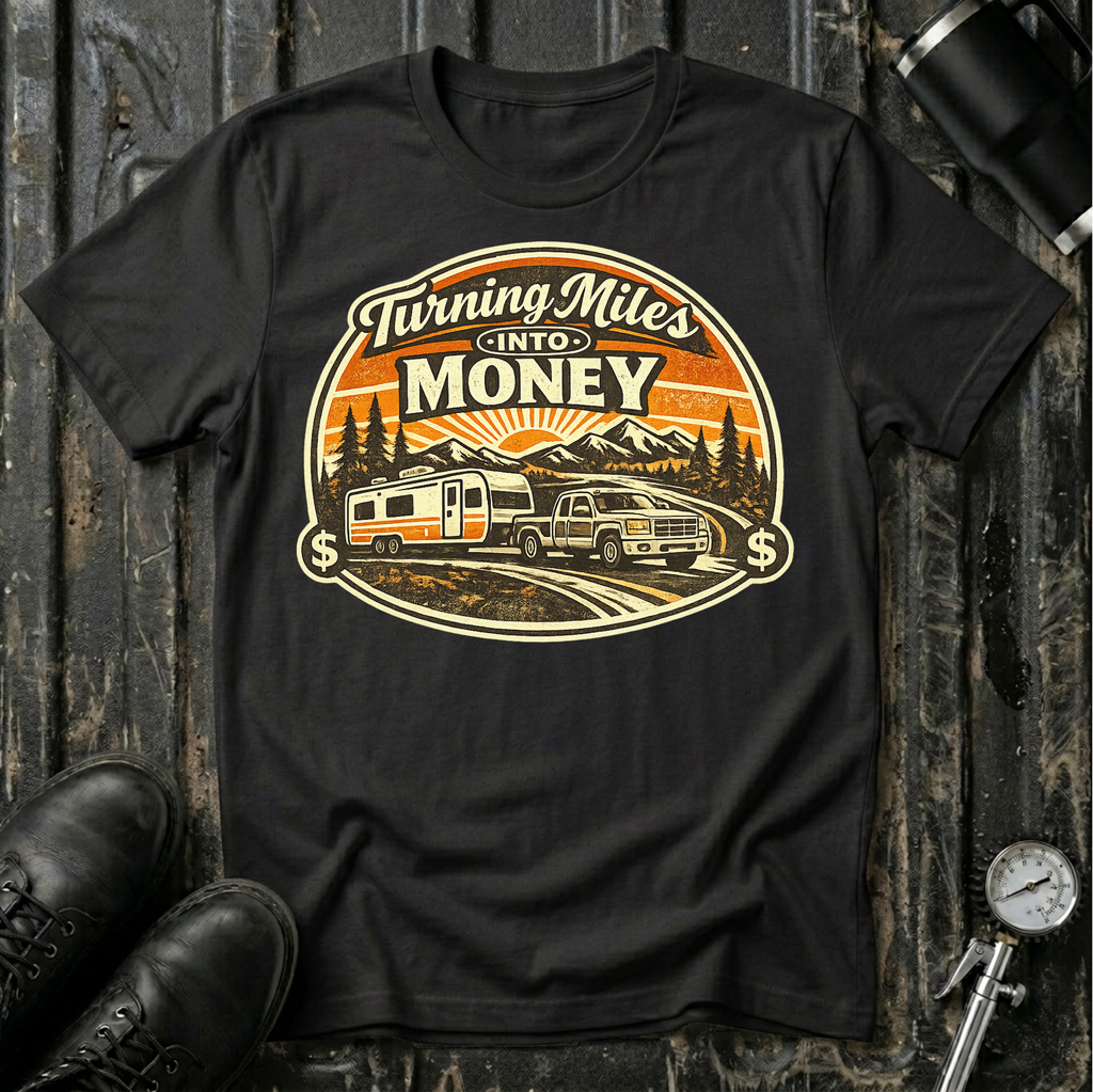 Turning Miles Into Money T-Shirt by The Riverstone Life on a black Gildan Softstyle 64000 featuring a pickup truck hauling an RV through a mountain landscape.