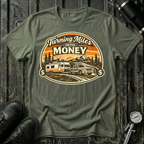 Turning Miles Into Money T-Shirt by The Riverstone Life on a military green Gildan Softstyle 64000 featuring a pickup truck hauling an RV through a mountain landscape.