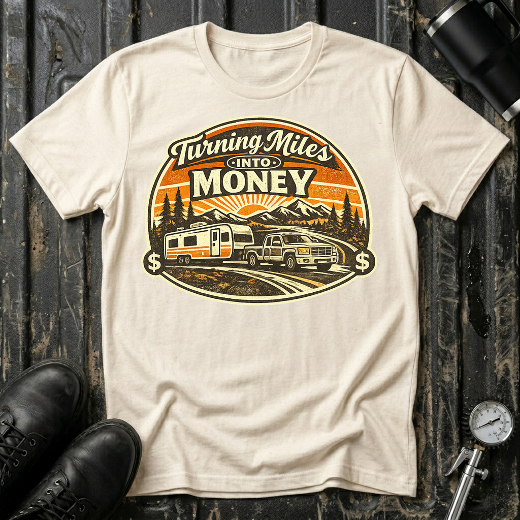 Turning Miles Into Money T-Shirt by The Riverstone Life on a natural Gildan Softstyle 64000 featuring a pickup truck hauling an RV through a mountain landscape.