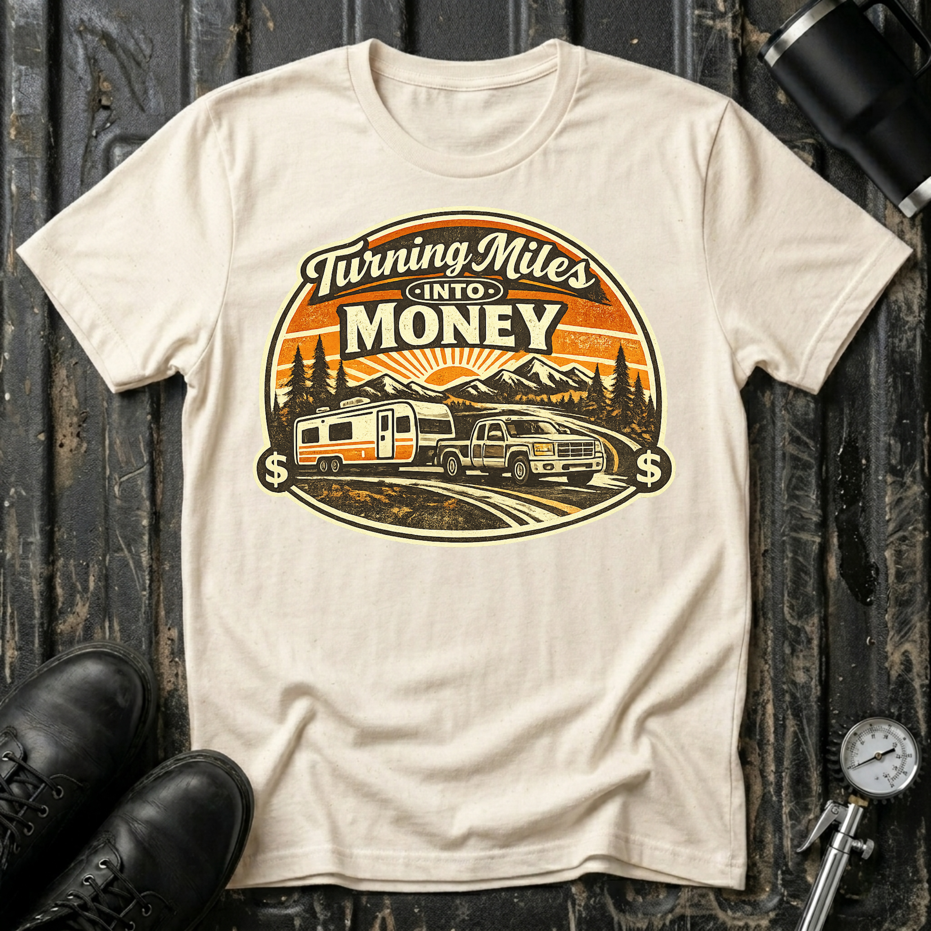 Turning Miles Into Money T-Shirt by The Riverstone Life on a natural Gildan Softstyle 64000 featuring a pickup truck hauling an RV through a mountain landscape.