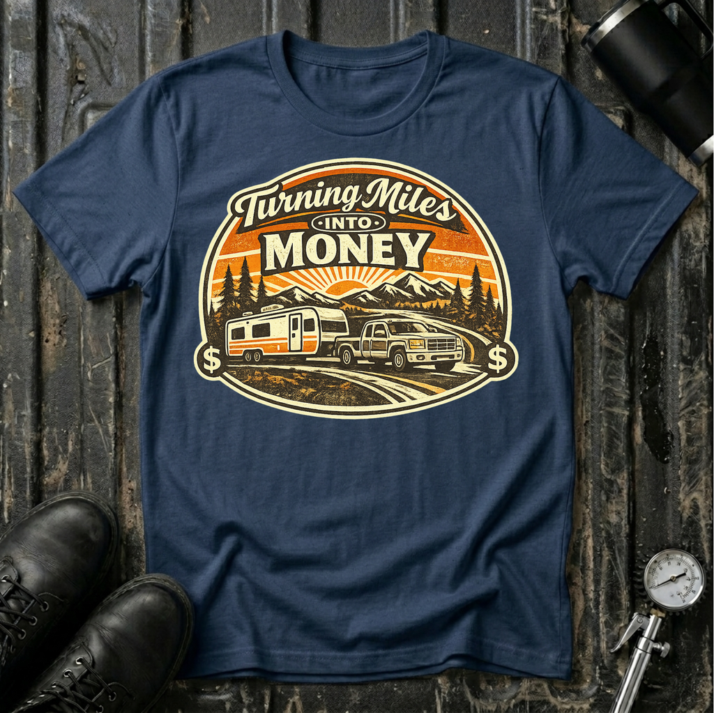Turning Miles Into Money T-Shirt by The Riverstone Life on a navy Gildan Softstyle 64000 featuring a pickup truck hauling an RV through a mountain landscape.