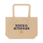 A beige canvas tote bag with the text 'WINTER IS BETTER WARM' in navy blue and a small orange sun graphic below, shown on a plain white background.
